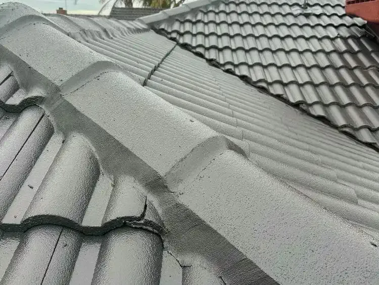 After: ridge capping rebedded and repointed