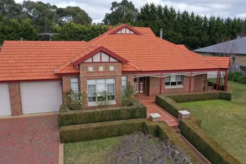 After: restored terracotta tiled roof with a bright, even finish
