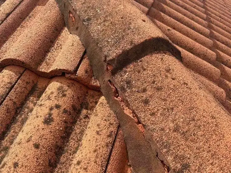 Before: cracked and deteriorated pointing on ridge capping