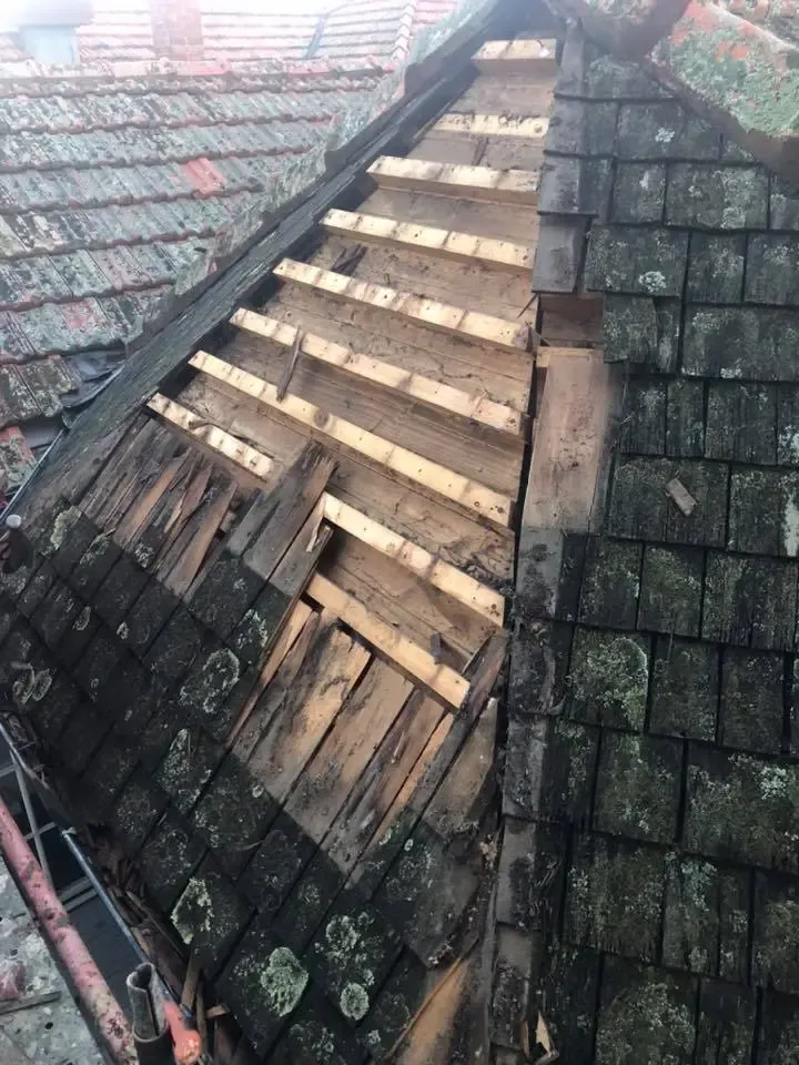 Before: a worn-out roof section stripped back to the battens