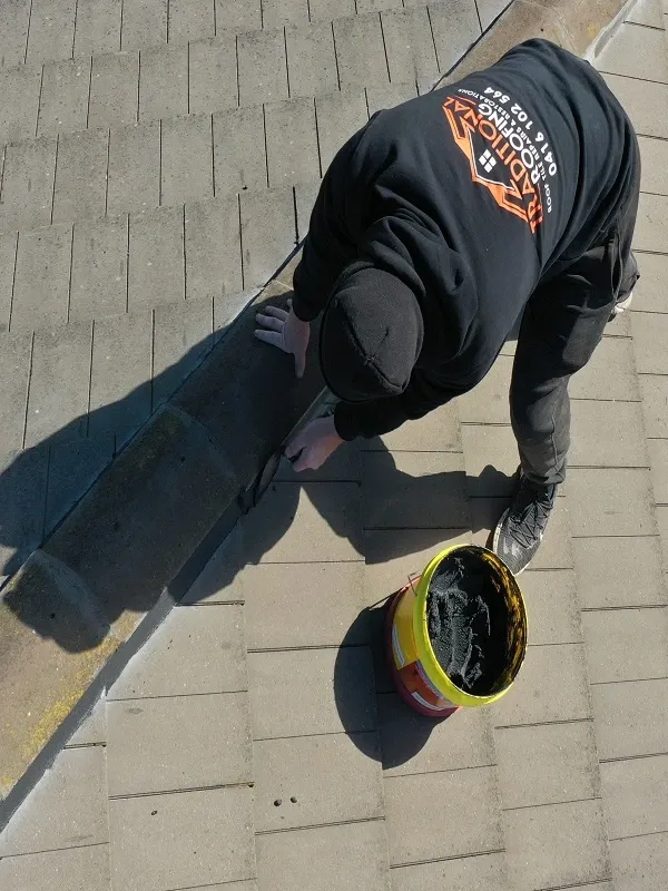 Drone view of our roofer repointing ridge capping on a concrete tiled roof
