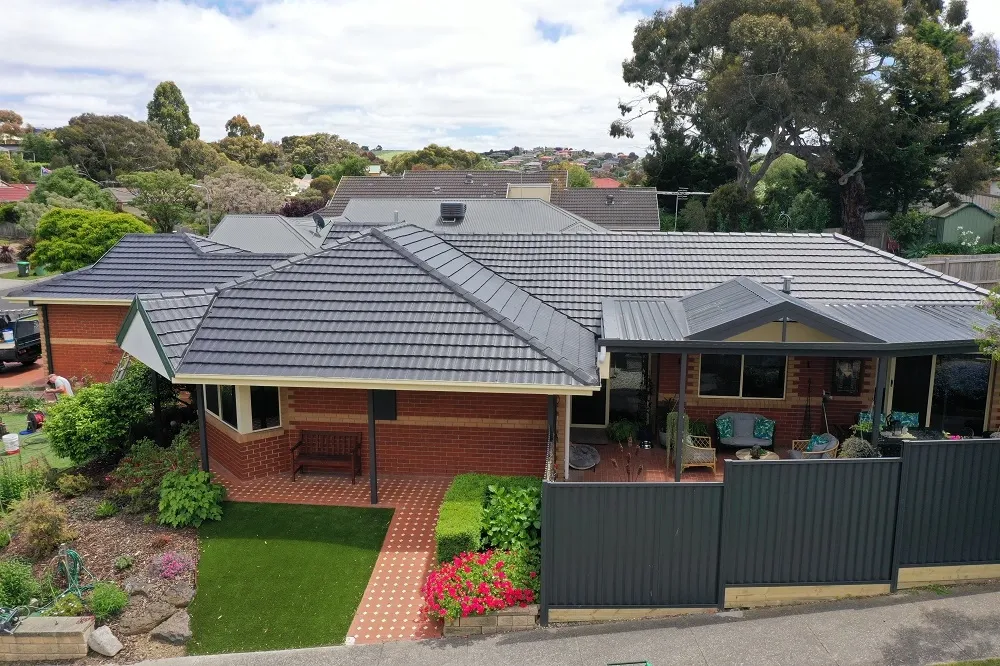 Charcoal concrete tiled roof on a brick home in Melbourne