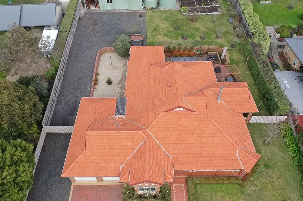 Drone view of a bright, restored terracotta tiled roof